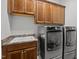Functional laundry room equipped with modern washer and dryer units and ample cabinet space at 946 Berry Patch Ln, Pittsboro, NC 27312