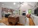 Open-concept space with kitchen view, hardwood floors, fireplace, and vaulted ceiling at 946 Berry Patch Ln, Pittsboro, NC 27312
