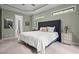 Serene main bedroom featuring neutral tones, plush carpet, and a tray ceiling at 946 Berry Patch Ln, Pittsboro, NC 27312