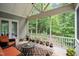 Relax on this covered porch, furnished with comfortable seating and surrounded by plants and scenic view at 946 Berry Patch Ln, Pittsboro, NC 27312