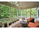 Relax on this covered porch, furnished with comfortable seating and a scenic view of the surrounding greenery at 946 Berry Patch Ln, Pittsboro, NC 27312