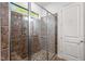 Walk-in shower featuring tiled walls, a glass door, and ample natural light at 946 Berry Patch Ln, Pittsboro, NC 27312