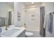 Well-lit bathroom features a shower-over-tub and a single sink with neutral color palette at 1012 Addison Pl, Raleigh, NC 27610