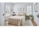 Bright bedroom featuring shuttered windows, hardwood floors, and neutral decor for a serene and inviting atmosphere at 1012 Addison Pl, Raleigh, NC 27610