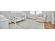 Cozy Bedroom with white crib, decorative chair, neutral tones and patterned rug at 1012 Addison Pl, Raleigh, NC 27610