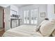 Well-lit bedroom featuring a comfortable bed and desk, perfect for a home office with bright shuttered windows at 1012 Addison Pl, Raleigh, NC 27610