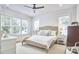 Bright bedroom with large windows, a ceiling fan, and light wood floors, offering a serene retreat at 1012 Addison Pl, Raleigh, NC 27610
