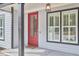 Charming front door with a pop of color, enhanced by windows with plantation shutters at 1012 Addison Pl, Raleigh, NC 27610