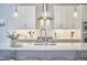 Open kitchen design featuring white cabinetry, stainless steel appliances, and a kitchen island with barstool seating at 1012 Addison Pl, Raleigh, NC 27610