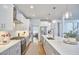 Modern kitchen with a large island, white cabinets, stainless steel appliances, and pendant lighting at 1012 Addison Pl, Raleigh, NC 27610