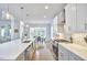 Modern kitchen with a large island, white cabinets, stainless steel appliances, and pendant lighting at 1012 Addison Pl, Raleigh, NC 27610