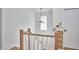 Upstairs landing with view of the stairs, modern railing and built in storage at 1012 Addison Pl, Raleigh, NC 27610