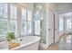 Bright bathroom featuring a soaking tub, shuttered windows, and stylish floral wallpaper at 1016 Addison Pl, Raleigh, NC 27610