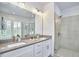 Elegant bathroom with double vanity, glass shower, and modern lighting fixtures at 1016 Addison Pl, Raleigh, NC 27610
