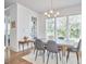 Bright dining room features a modern chandelier, large windows, and a neutral color palette at 1016 Addison Pl, Raleigh, NC 27610