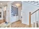 Inviting entryway featuring beautiful hardwood floors, white cabinets, and decorative wall paper at 1016 Addison Pl, Raleigh, NC 27610