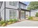 Charming two-story home with a well-manicured lawn, attractive landscaping, and covered porch with brick steps at 1016 Addison Pl, Raleigh, NC 27610
