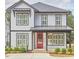 Charming two-story home with a red front door, landscaped yard, and a modern design at 1016 Addison Pl, Raleigh, NC 27610