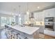 The eat-in kitchen has custom cabinets, stainless appliances, a functional island, and upgraded finishes at 1016 Addison Pl, Raleigh, NC 27610