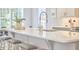 The bright eat-in kitchen is complete with a large island, stylish seating, and modern appliances at 1016 Addison Pl, Raleigh, NC 27610