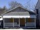 Modest single-story home with covered porch and white lattice accents on the railing at 1117 S Blount St, Raleigh, NC 27601