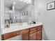Bathroom with vanity, large mirror, shower and tub combination, and window at 112 E Main St, Micro, NC 27555