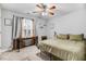 Bedroom with a neutral color scheme, a desk, and a ceiling fan at 112 E Main St, Micro, NC 27555