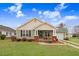 Charming home featuring a cozy front porch with rocking chairs, a well-manicured lawn, and delightful curb appeal at 112 E Main St, Micro, NC 27555
