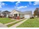 Charming home with an attached garage, showcasing a well-maintained lawn and inviting curb appeal at 112 E Main St, Micro, NC 27555