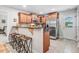 Stylish kitchen featuring stainless steel appliances, wooden cabinetry, and a breakfast bar with modern seating at 112 E Main St, Micro, NC 27555