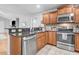 This is a beautiful kitchen with stainless steel appliances, granite countertops, and wood cabinets at 112 E Main St, Micro, NC 27555