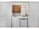 This laundry room features a washer, dryer, and upper cabinets at 112 E Main St, Micro, NC 27555