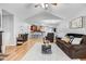 Open-concept living room with hardwood floors, vaulted ceiling, and seamless flow into the kitchen area at 112 E Main St, Micro, NC 27555
