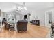 Spacious living area featuring hardwood floors, vaulted ceiling, and seamless transition to the kitchen at 112 E Main St, Micro, NC 27555