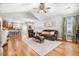 Inviting living room featuring hardwood floors, vaulted ceiling, and an open layout connecting to the kitchen at 112 E Main St, Micro, NC 27555