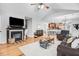 Bright living room featuring hardwood floors, fireplace, and seamless access to the adjoining kitchen at 112 E Main St, Micro, NC 27555