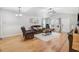 Warm living room with hardwood floors and open layout leading to a bright window view at 112 E Main St, Micro, NC 27555