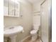 A clean, functional bathroom featuring a pedestal sink, toilet, and a glass-enclosed shower at 118 Park Ave, Knightdale, NC 27545