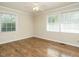 Bright bedroom featuring hardwood floors, neutral walls and natural light from the double windows at 118 Park Ave, Knightdale, NC 27545