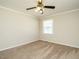 Bedroom features neutral paint, plush carpet, natural light from the windows at 118 Park Ave, Knightdale, NC 27545