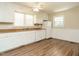 Kitchen features white cabinets, wood countertops, and newer appliances, a functional design at 118 Park Ave, Knightdale, NC 27545