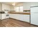 Kitchen features white cabinets, wood countertops, and newer appliances for a functional design at 118 Park Ave, Knightdale, NC 27545
