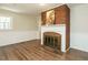Living room featuring a classic brick fireplace, neutral walls and white trim at 118 Park Ave, Knightdale, NC 27545