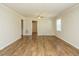 Bright living room featuring hardwood floors, neutral paint, and natural light from the window at 118 Park Ave, Knightdale, NC 27545