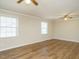 Bright living room featuring hardwood floors, crown molding, and natural lighting at 118 Park Ave, Knightdale, NC 27545