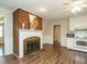 Living room featuring a classic brick fireplace and a pass-through to the adjacent kitchen at 118 Park Ave, Knightdale, NC 27545