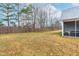 Spacious backyard featuring a wooden fence and a screened-in porch with comfortable seating at 120 Longspur Ln, Rolesville, NC 27571