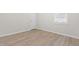 Bright bedroom with neutral walls, wood-look flooring, and a sunny window at 120 Longspur Ln, Rolesville, NC 27571