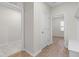Inviting hallway with wood-look floors, white walls, and entry to adjacent rooms at 120 Longspur Ln, Rolesville, NC 27571