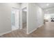 Bright hallway with hardwood floors leads to a bathroom, bedroom, and open living space at 120 Longspur Ln, Rolesville, NC 27571